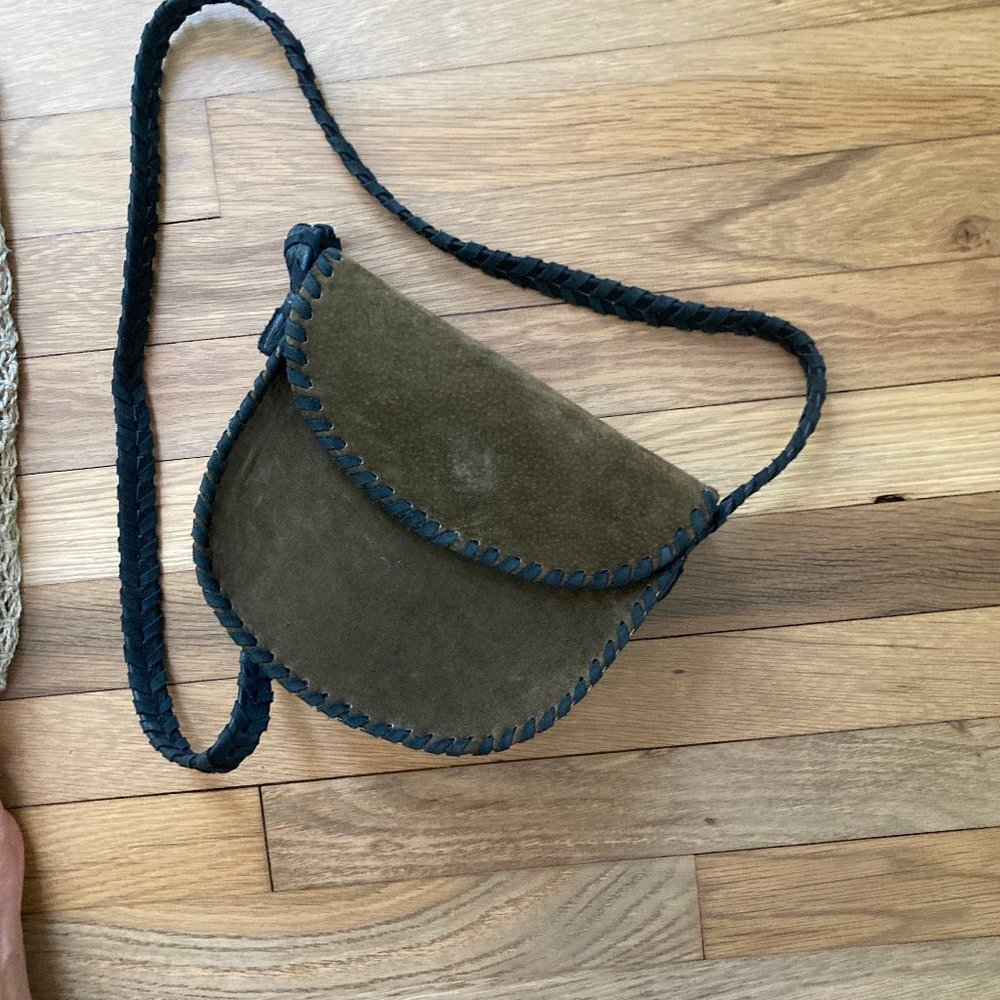 Green leather bag with black strap and silver detailed bottom